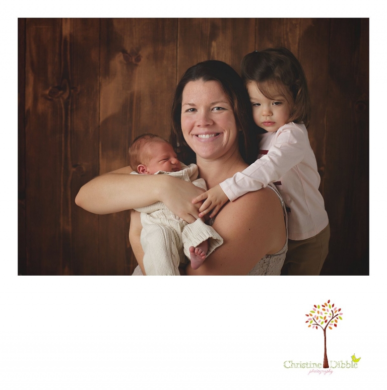 Sonora newborn photographer Christine Dibble Photography takes photos of a baby boy snuggled with his mother and big sister.