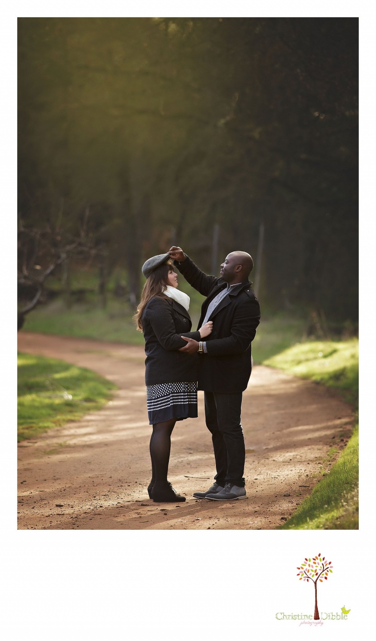 Sonora engagement and wedding photographer Christine Dibble Photography takes photos at Indigeny Reserve as a groom puts his newsboy cap on the bride's head.