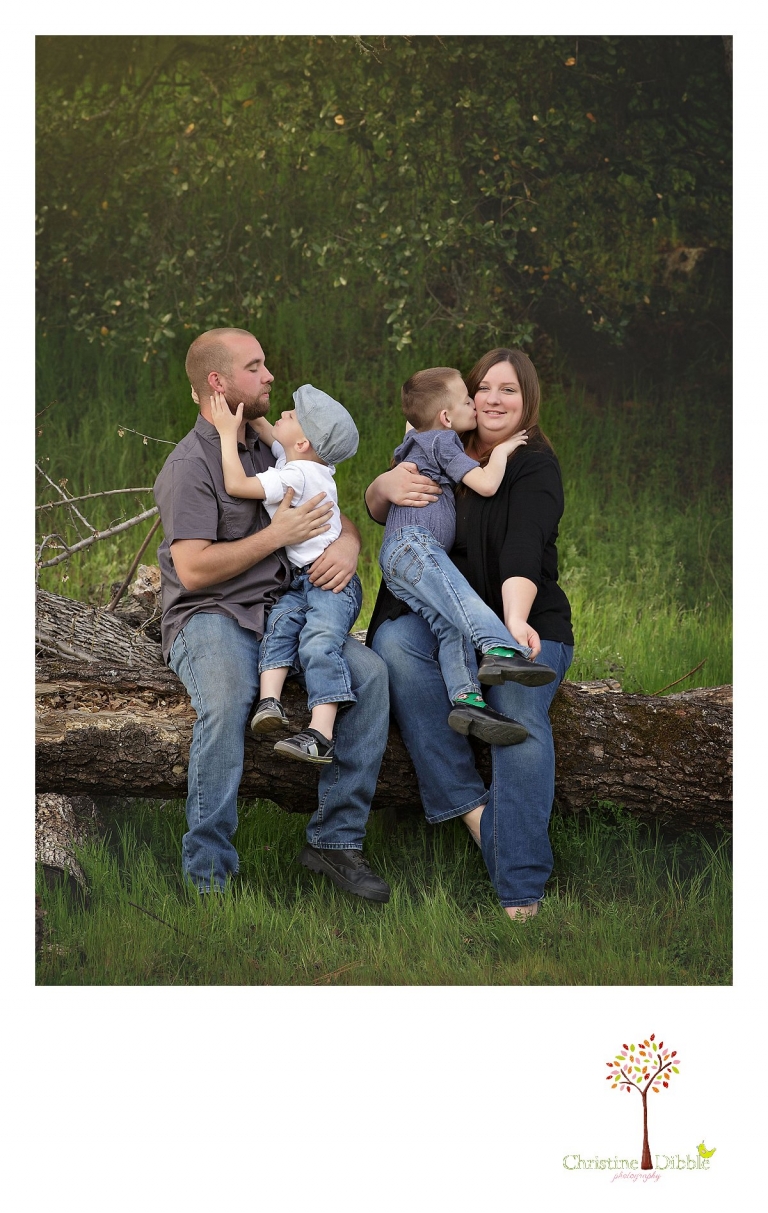 Sonora family photographer Christine Dibble Photography takes outdoor family photos at Indigeny Reserve of a family cuddling on a log.