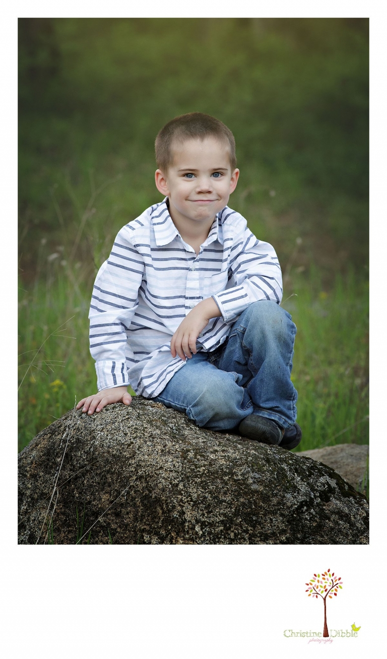 Sonora family photographer Christine Dibble Photography takes outdoor family photos at Indigeny Reserve of a boy sitting on a granite rock.