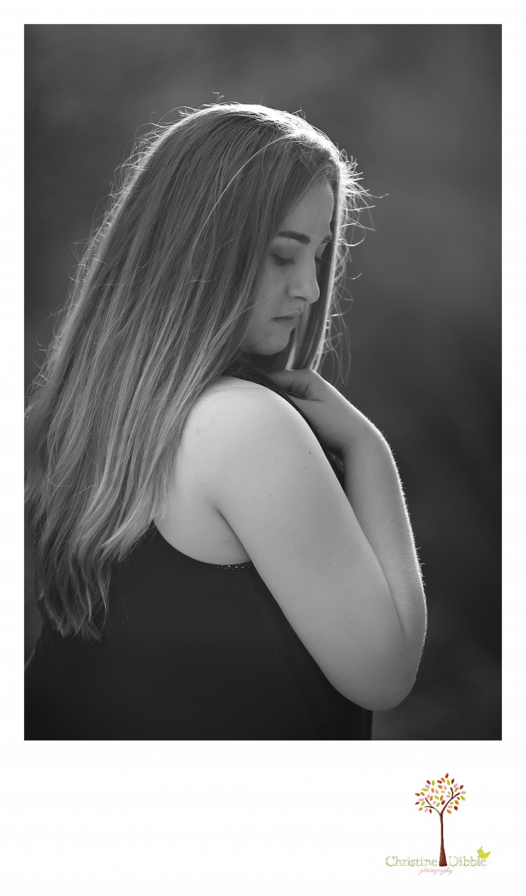 Sonora High senior portrait photographer Christine Dibble Photography takes a black and white portrait of a senior girl using the setting sun as a rim light.