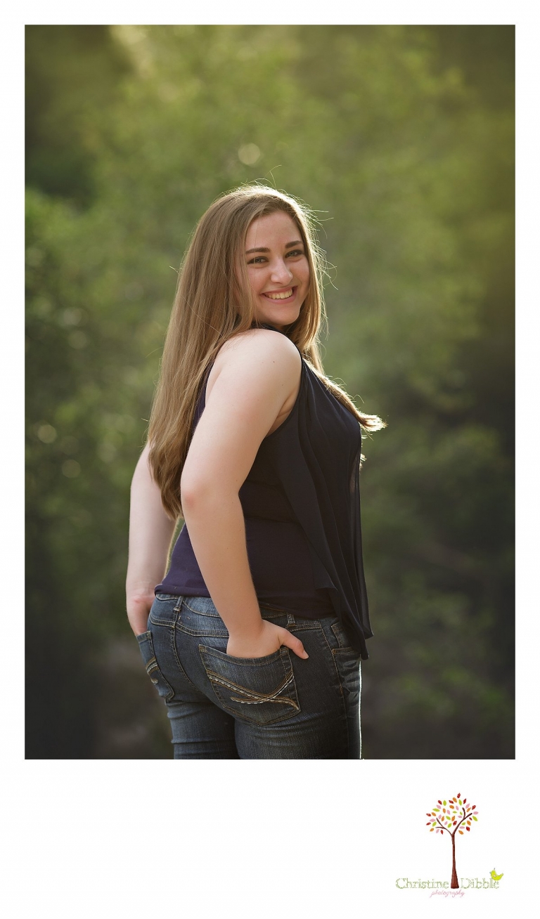 Sonora High senior portrait photographer Christine Dibble Photography takes color photos of a senior girl in a wooded setting.