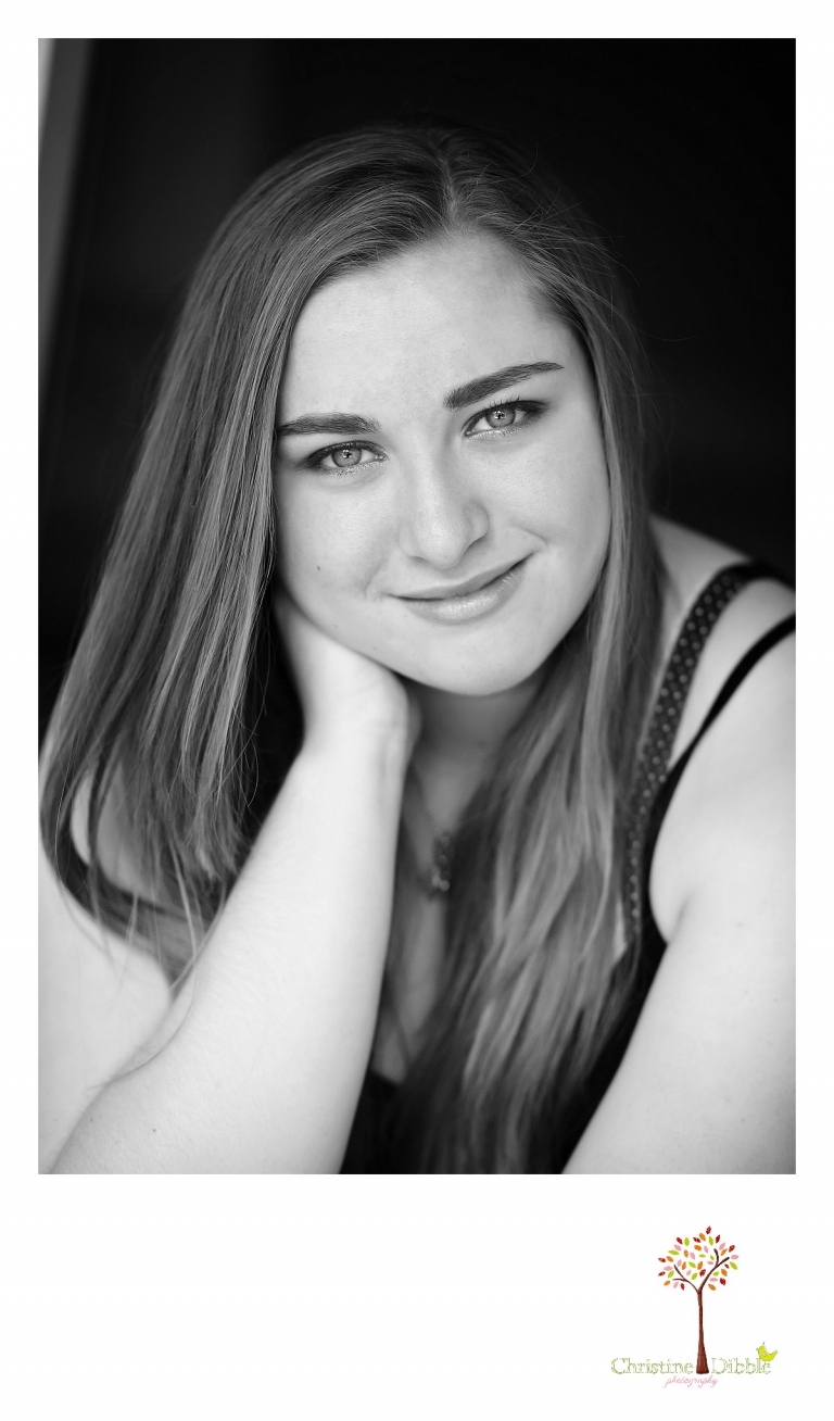 Sonora High senior portrait photographer Christine Dibble Photography takes a black and white head shot of a senior girl in the doorway of an old Jamestown home during her portrait session.