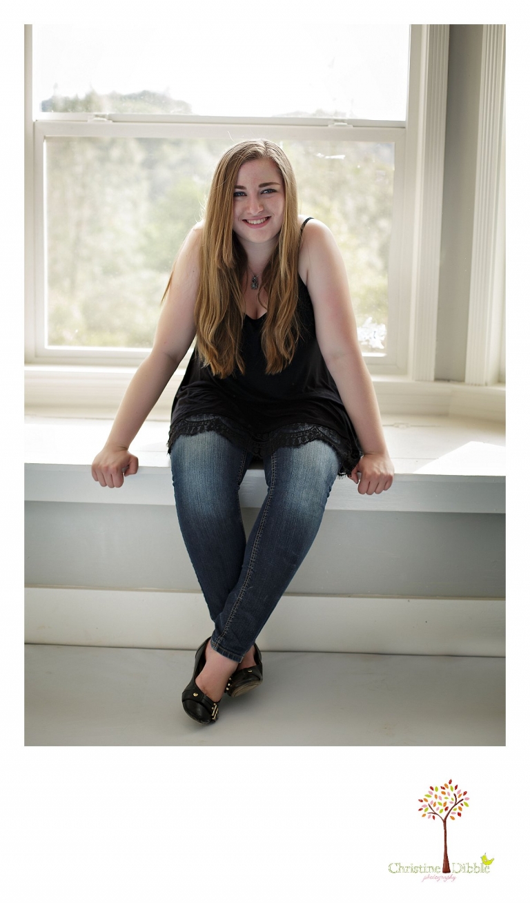 Sonora High senior portrait photographer Christine Dibble Photography takes a photo of a senior girl on a window seat in an old house.