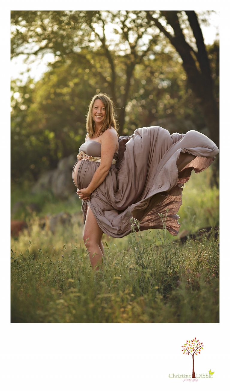 Sonora maternity photographer Christine Dibble Photography captures a maternity dress billowing in the wind during a pregnancy photo shoot outdoors.