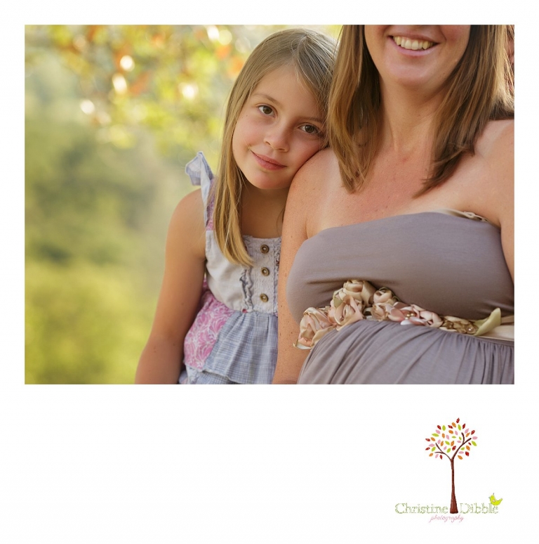 Sonora maternity photographer Christine Dibble Photography takes photos of a little girl with her hand on her mother's pregnant belly.
