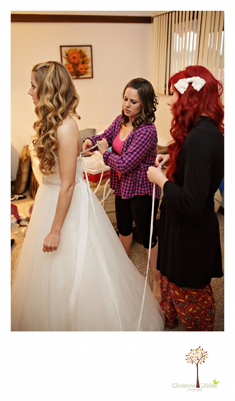The bride has her dress laced by her bridesmaids as Don Pedro Hacienda photographer Christine Dibble Photography of Sonora takes photos.