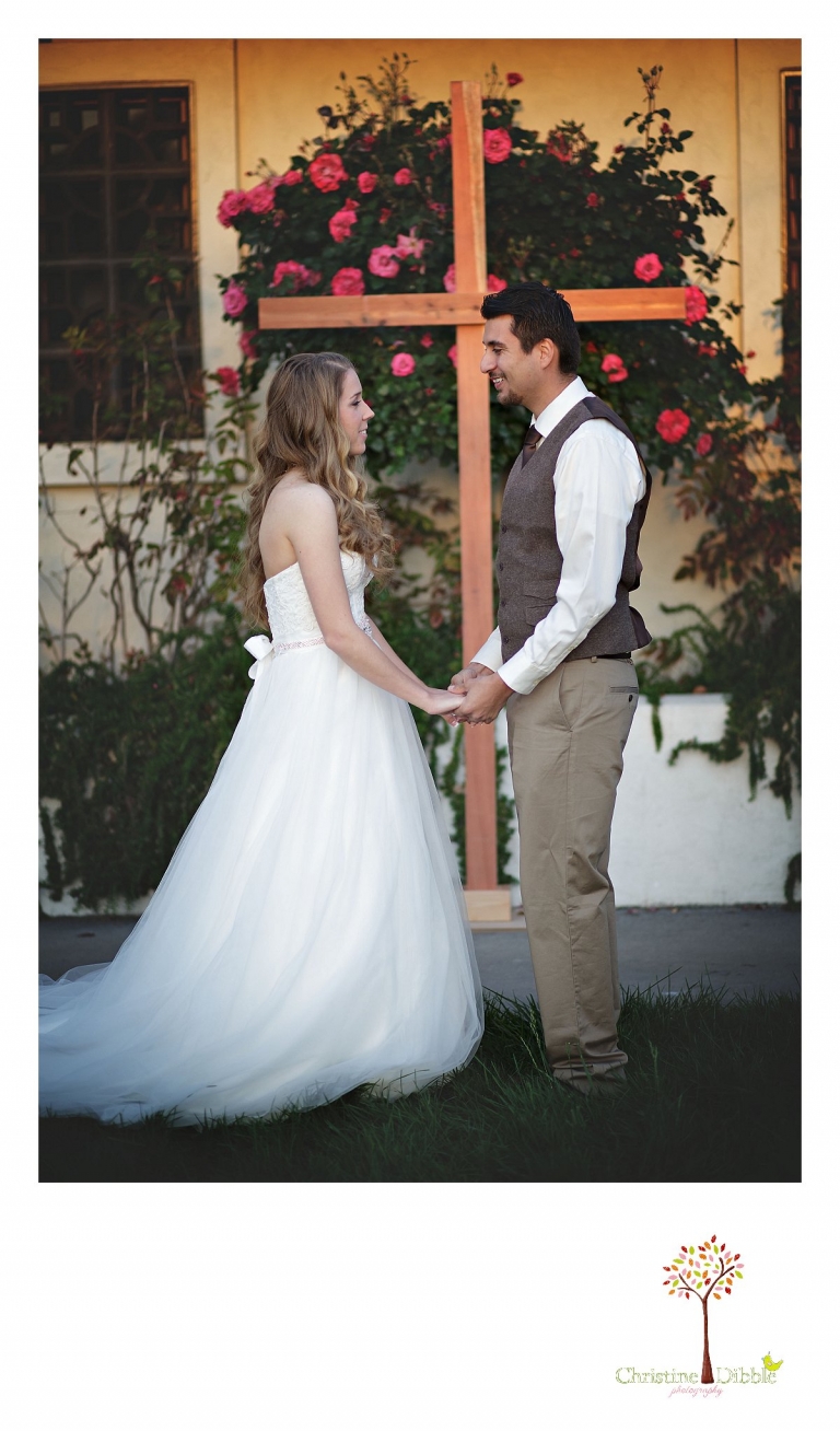 Don Pedro Hacienda photographer Christine Dibble Photography of Sonora photograph the bride and groom as they stand at the large wooden cross at the altar for their wedding ceremony.