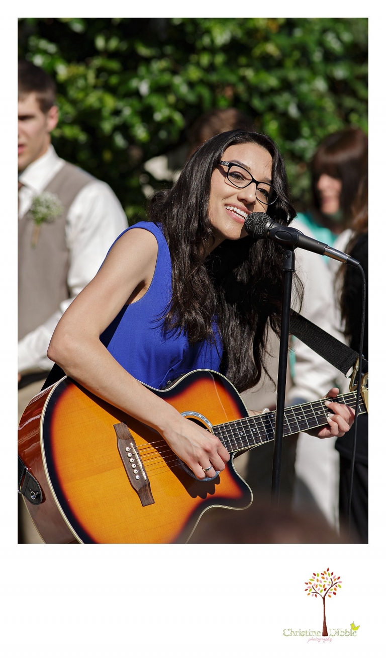 Don Pedro Hacienda photographer, Sonora wedding photographer Christine Dibble Photography photographs a singer as she sings and plays her guitar during the wedding ceremony.