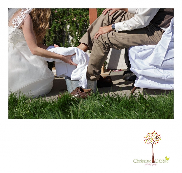A bride washes her groom's feet during a wedding ceremony photographed by Don Pedro Hacienda photographer, Sonora wedding photographer Christine Dibble Photography.