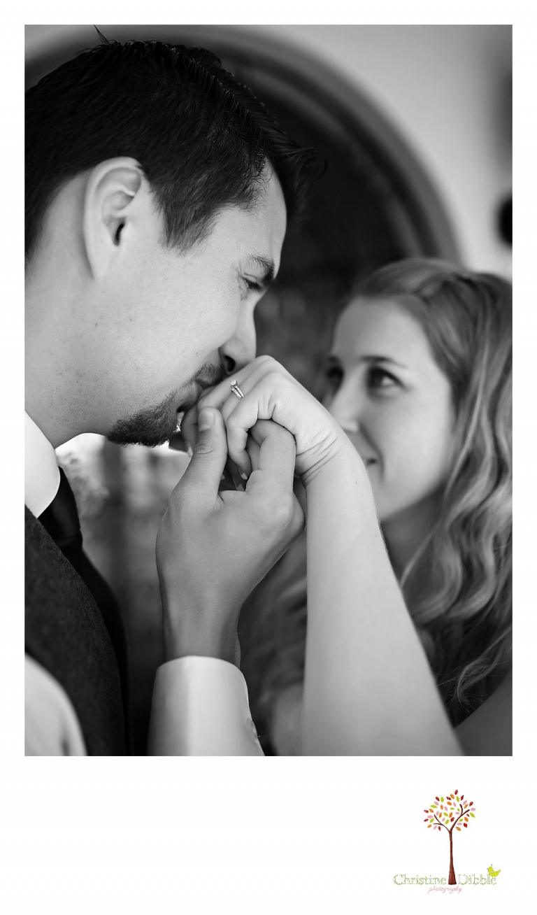 The groom kisses his bride's hand and shows off her new ring as Don Pedro Hacienda photographer, Sonora wedding photographer Christine Dibble Photography takes a photo.