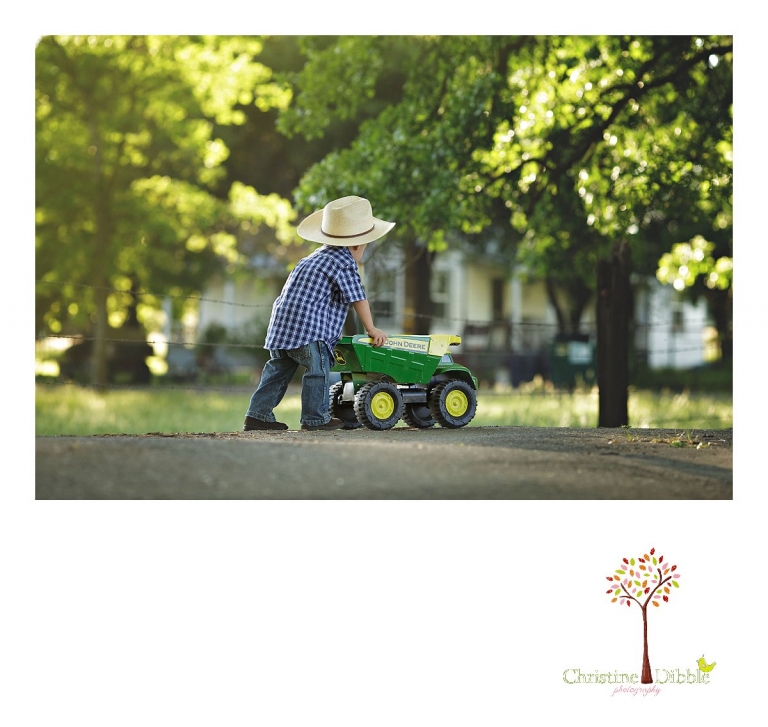 Sonora child photography by Christine Dibble Photography captures a three year old boy pushing his John Deere at a family ranch.