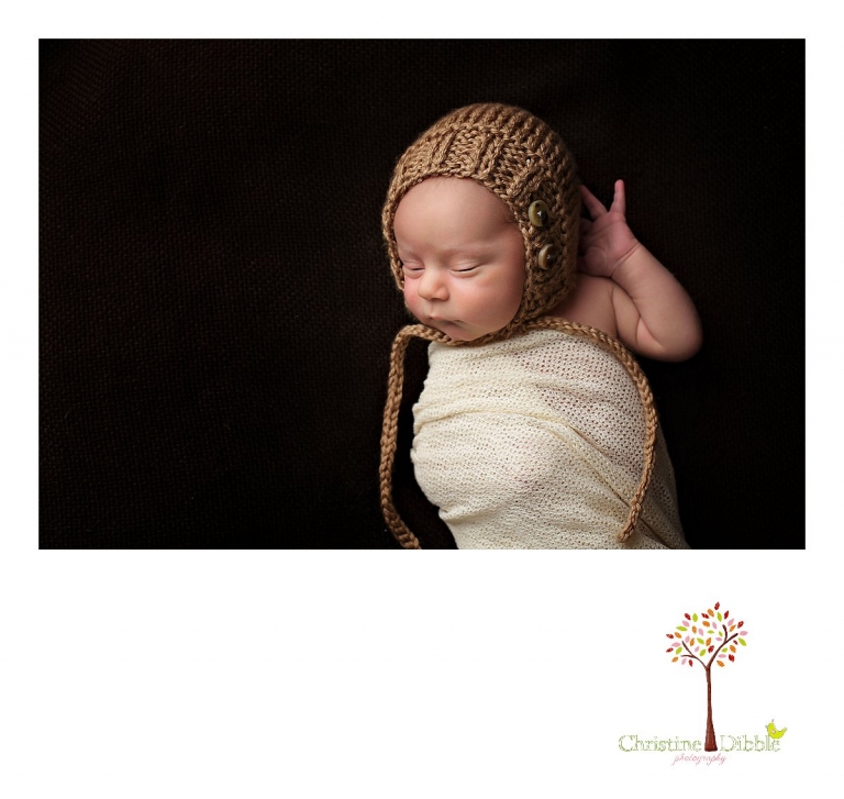 Best Sonora newborn photographer Christine Dibble Photography takes photos of a nine day old baby boy sleeping in a bonnet and a wrap.