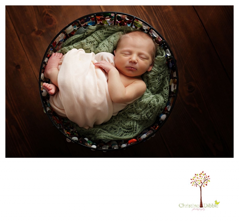 Sonora newborn photographer Christine Dibble Photography takes photos of a baby girl sleeping in a handcrafted glass beaded bowl.