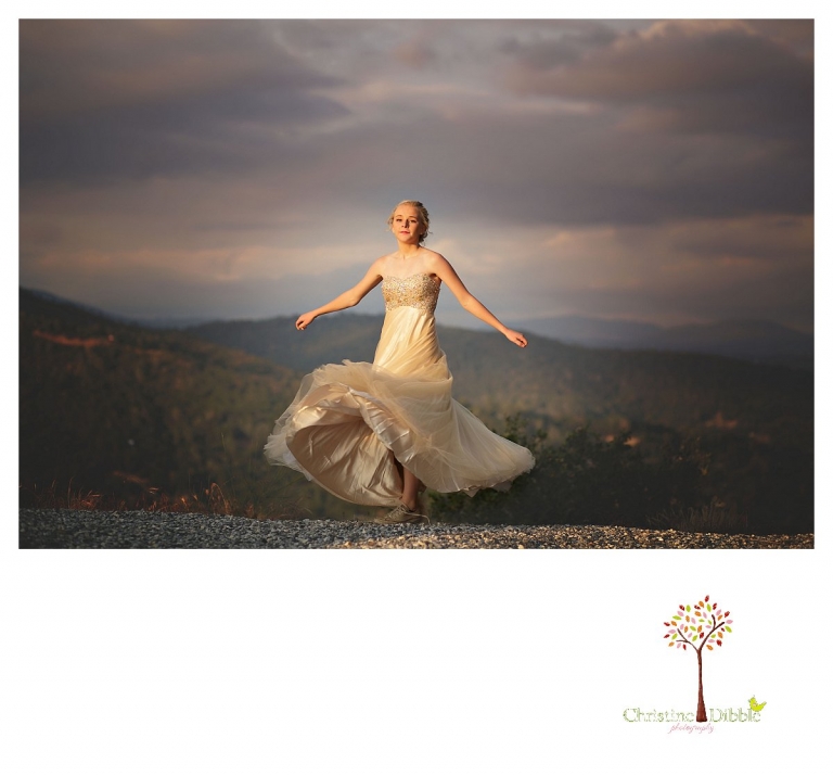 Sonora senior portrait photographer Christine Dibble Photography takes portraits of an eighth grade graduate in a formal gown as she spins in sunset light with downtown Sonora behind her.