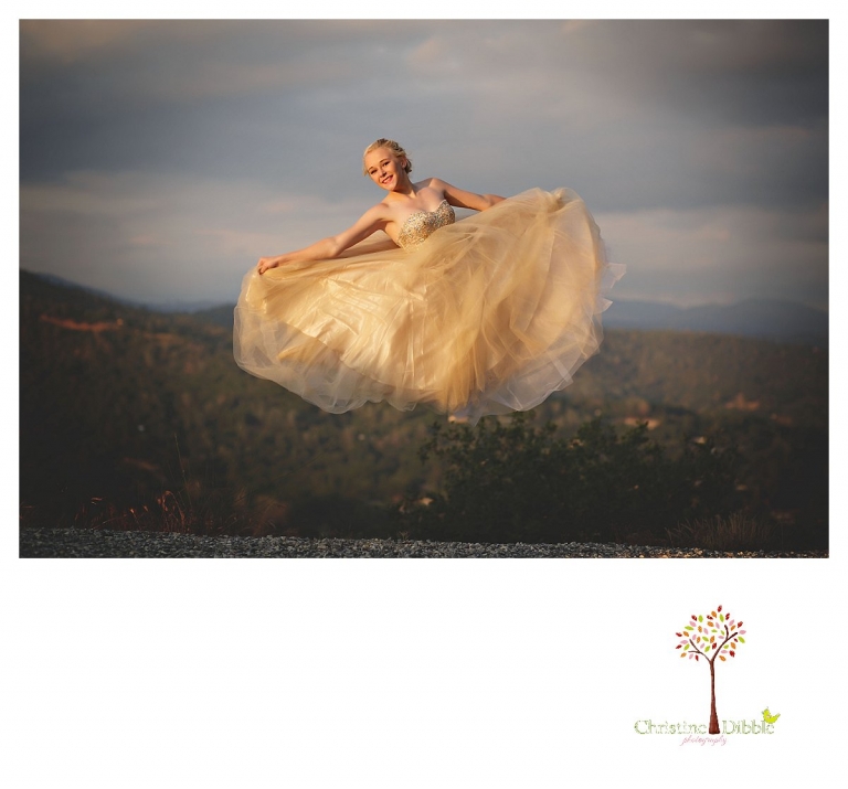 Sonora senior portrait photographer Christine Dibble Photography takes portraits of an eighth grade graduate in a formal gown pulling off a High School Musical jump with a view of Sonora.