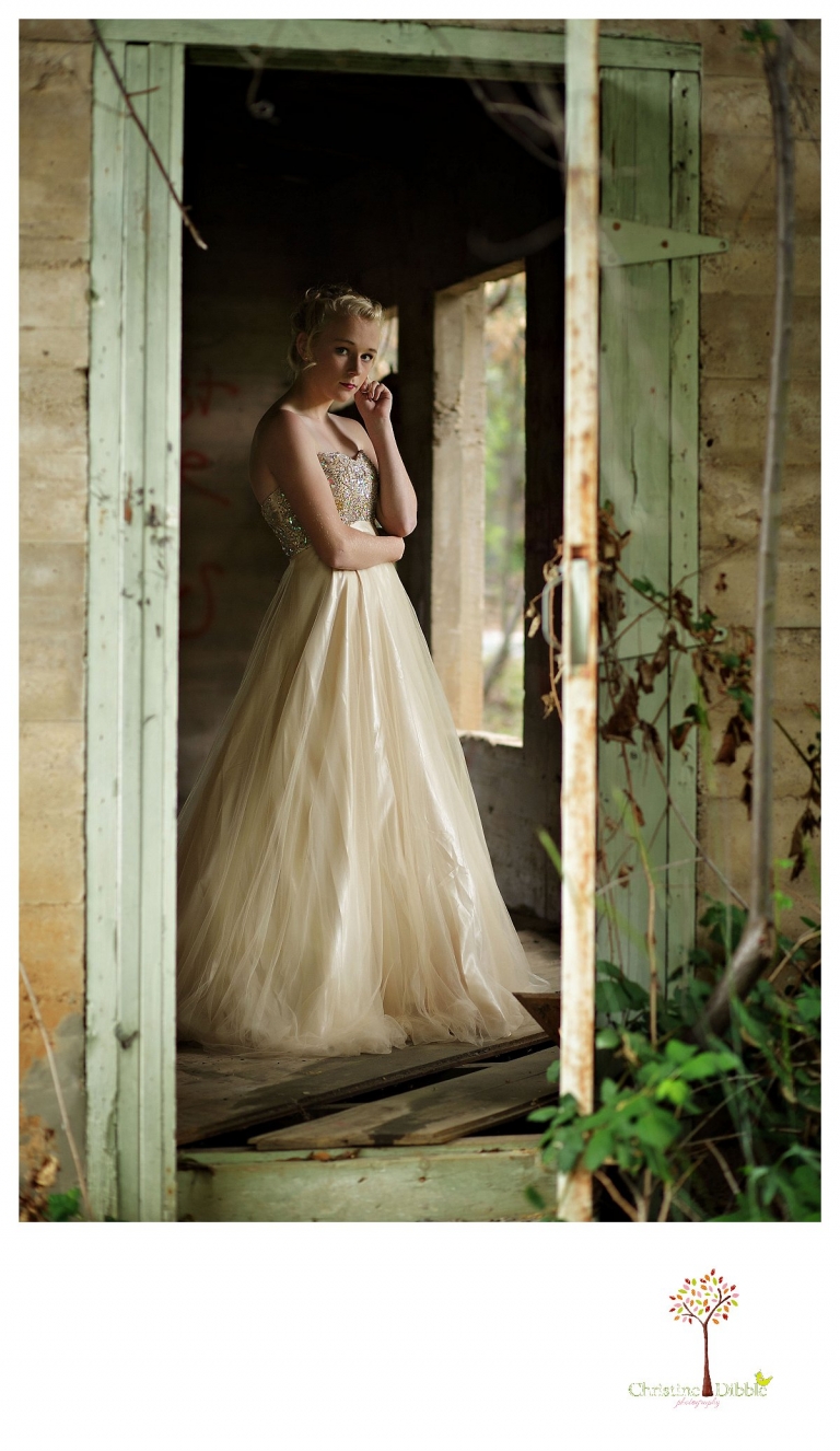 Sonora senior portrait photographer Christine Dibble Photography takes portraits of an eighth grade graduate in a formal gown in the doorway of an abandoned house.