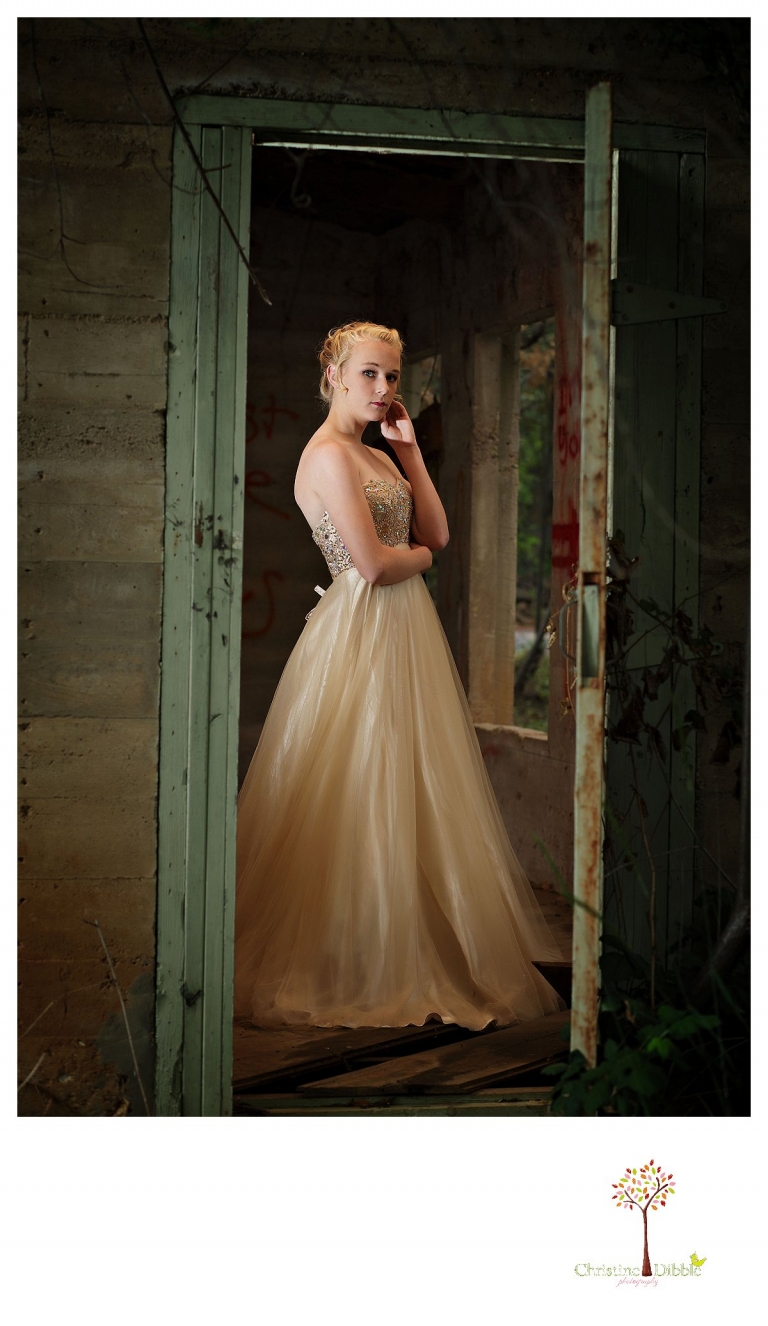 Sonora senior portrait photographer Christine Dibble Photography takes portraits of an eighth grade graduate in a formal gown in the doorway of an abandoned house.