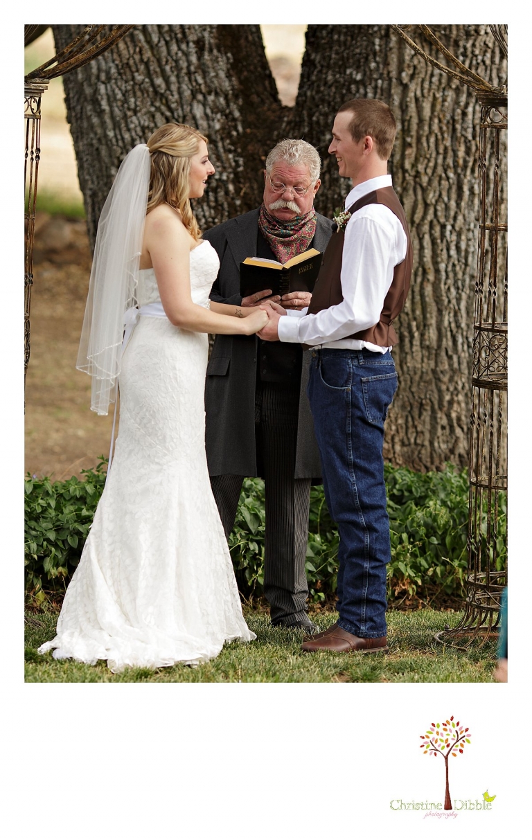 Sonora, CA wedding photography by Christine Dibble Photography captures the officiant reading from the Bible at a wedding ceremony.