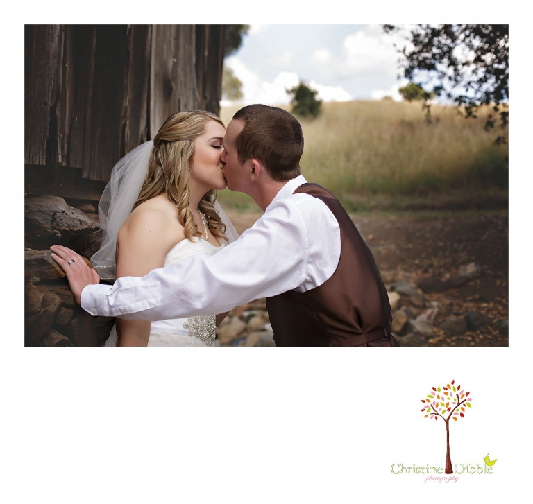 Sonora, CA wedding photography by Christine Dibble Photography captures a kiss by the bride and groom during portraits.