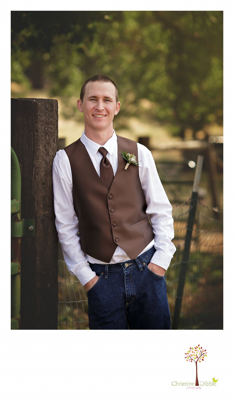 Sonora, CA wedding photography by Christine Dibble Photography takes photos of the groom leaning against a ranch gate near a milk can.