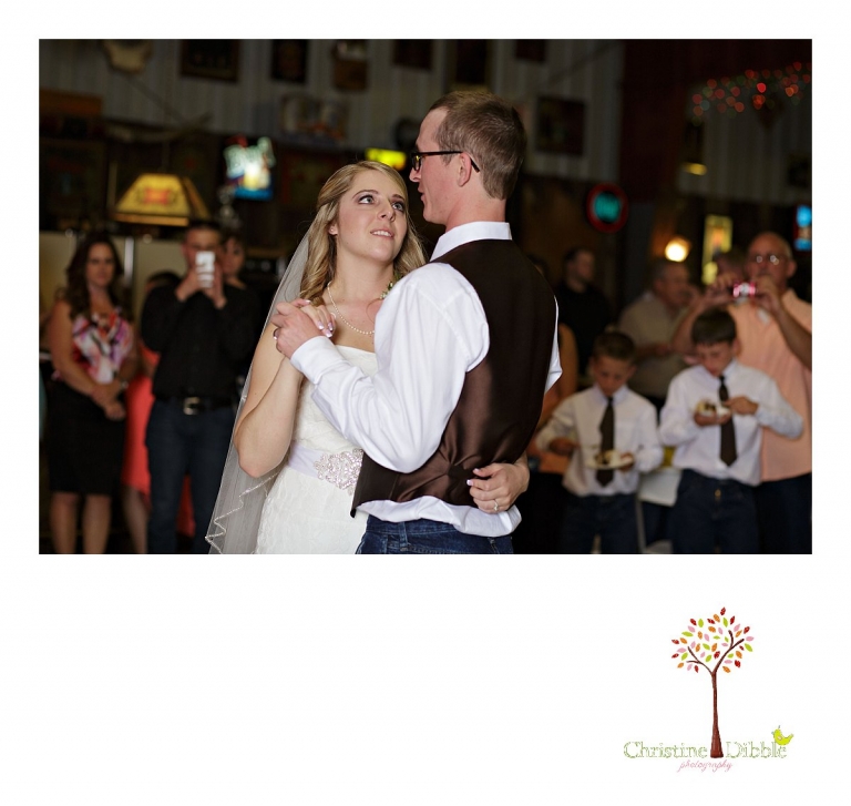 Sonora, CA wedding photographer Christine Dibble Photography takes pictures of a bride looking at her groom during their first dance.