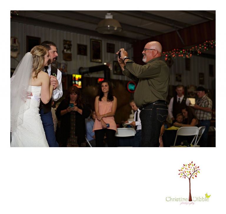 Sonora, CA wedding photographer Christine Dibble Photography takes photos of a guest photographing the bride and her father as they dance.