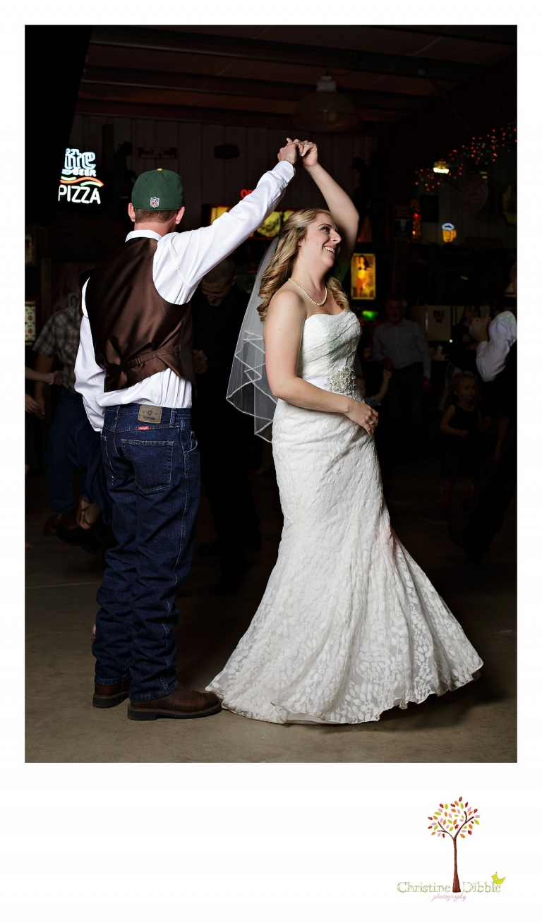 Sonora, CA wedding photographer Christine Dibble Photography takes photos of a bride and groom spinning as they dance.