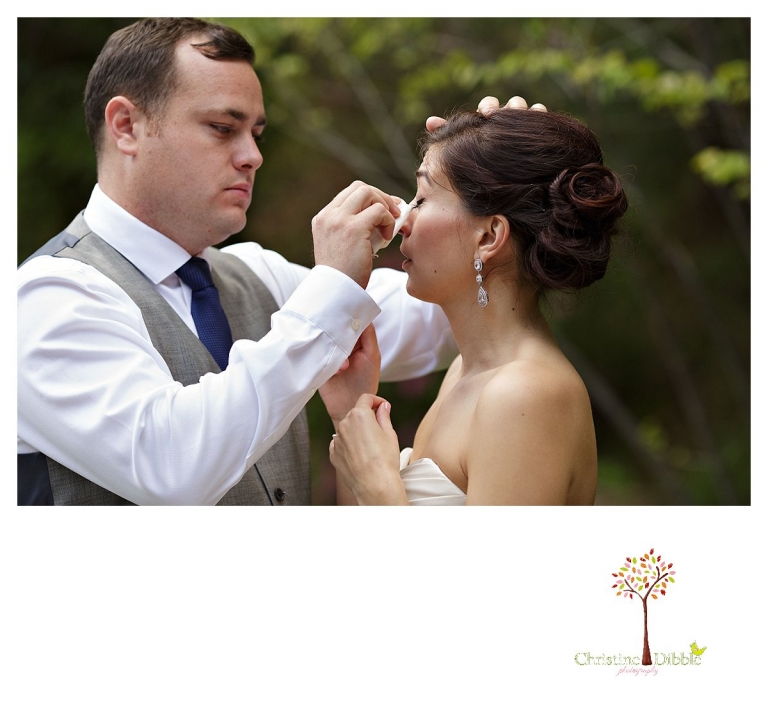 Sonora wedding photographer Christine Dibble Photography photographs a Twain Harte Tree Farm wedding and the groom drying the bride's tears.
