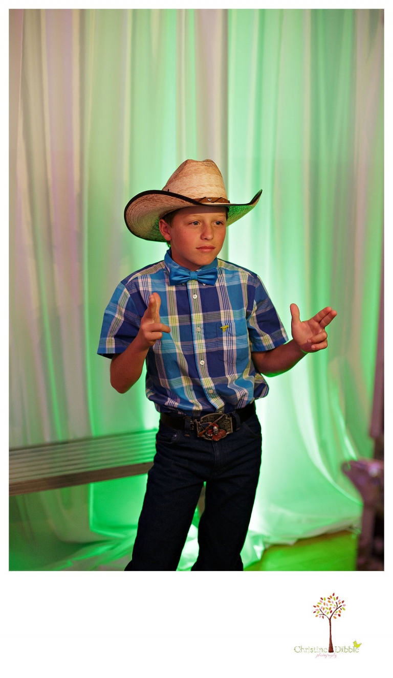 Sonora graduation and senior portrait photographer Christine Dibble Photography takes eighth grade graduation photos of a cowboy in the dance photo booth.