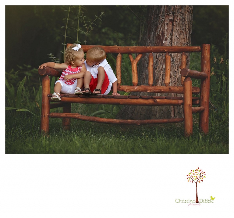 Twain Harte Tree Farm and Sonora child photographer Christine Dibble Photography takes photos of three visiting cousins and brother and sister sitting on a bench.