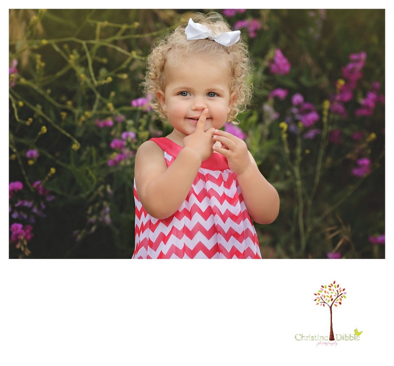 Twain Harte Tree Farm and Sonora child photographer Christine Dibble Photography takes photos of three visiting cousins and a girl in front of sweet peas.