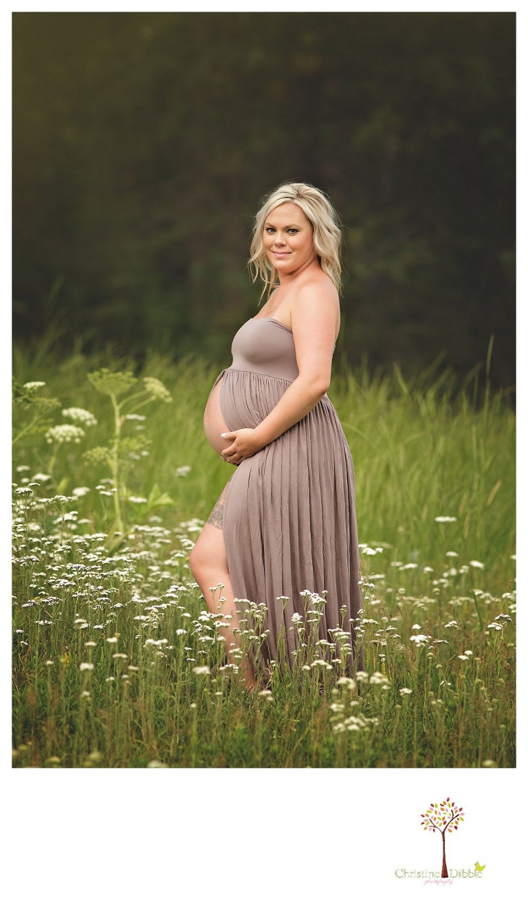 Sonora maternity photographer Christine Dibble Photography takes pregnant belly bump photos of a mom in a belly dress in a field of wildflowers.