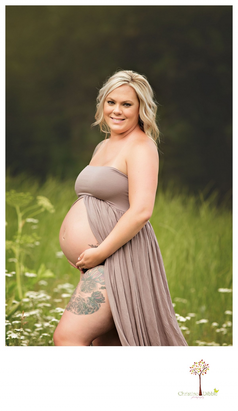 Sonora maternity photographer Christine Dibble Photography takes pregnant belly portraits of a tattoed mom in a belly dress shoeing her baby bump.