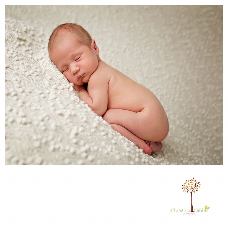 Sonora newborn and baby photographer Christine Dibble Photography takes indoor studio portraits of a sleeping baby boy on a cream popcorn blanket.