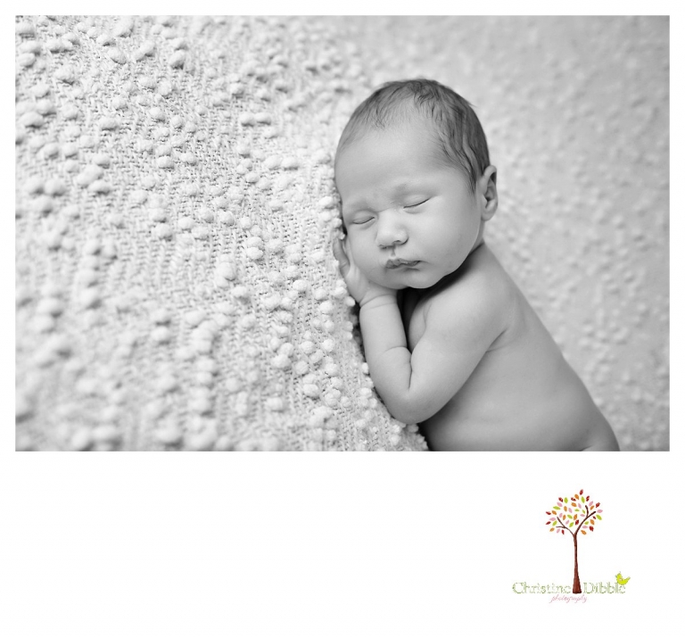 Sonora newborn and baby photographer Christine Dibble Photography takes indoor studio portraits in black and white of a sleeping baby.