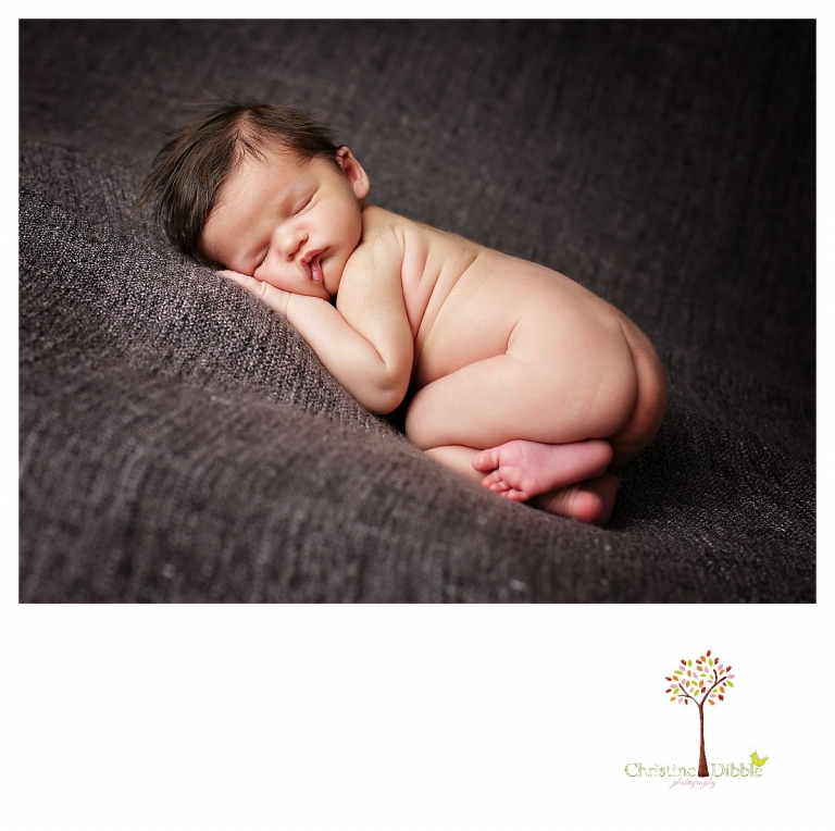 Newborn photography by best Sonora newborn photographer Christine Dibble Photography takes studio portraits of a naked sleeping baby boy.