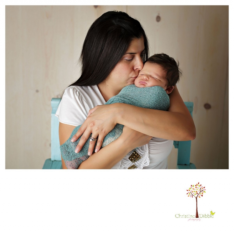 Newborn photography by best Sonora newborn photographer Christine Dibble Photography takes studio portraits of a new mom cuddling her baby boy.
