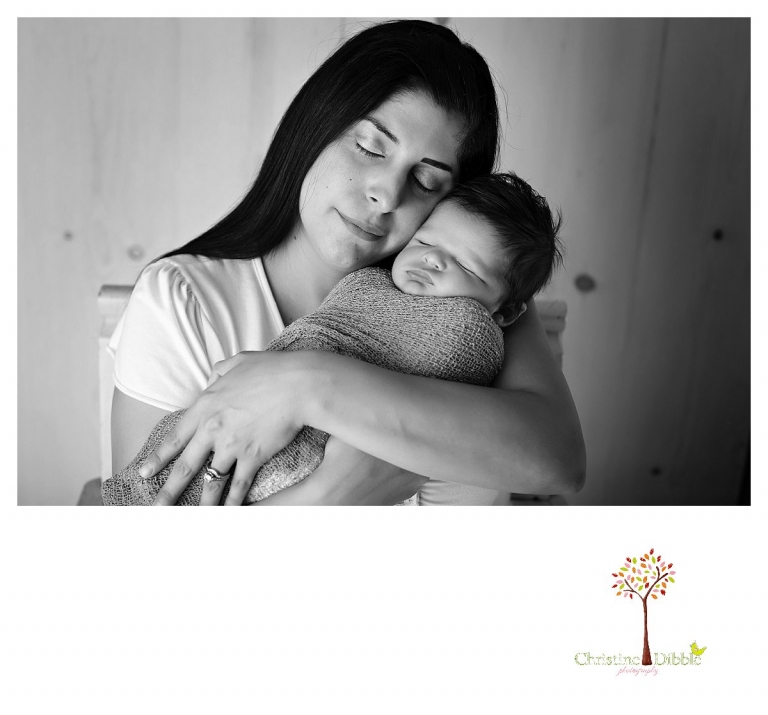 Newborn photography by best Sonora newborn photographer Christine Dibble Photography takes studio portraits of a mom posing cheek to cheek with her newborn baby boy.