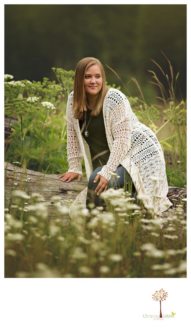 Sonora and Summerville senior portrait photographer Christine Dibble Photography takes outdoor senior portraits of a girl sitting on a fallen tree.