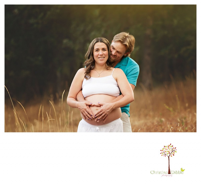 Sonora maternity photography session by Christine Dibble Photography shows a dad hugging his pregnant wife.