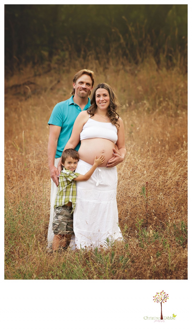 Sonora maternity photography session by Christine Dibble Photography shows a pregnant woman, dad and the big brother posing for a family portrait.