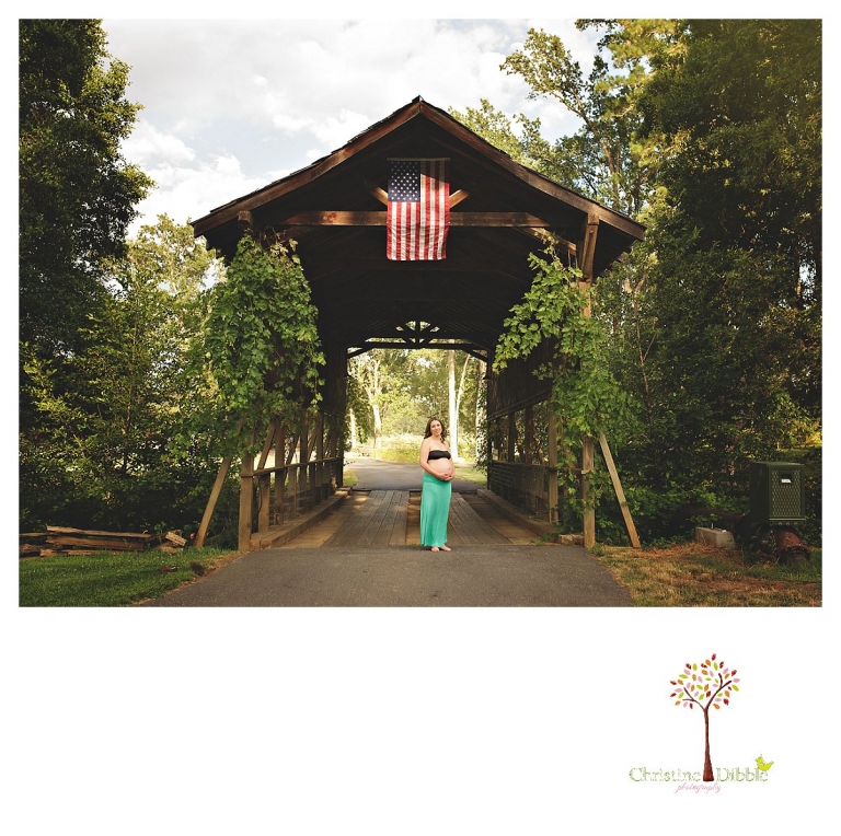Sonora maternity photography session by Christine Dibble Photography shows a pregnant woman standing in front of the Indigeny covered bridge.