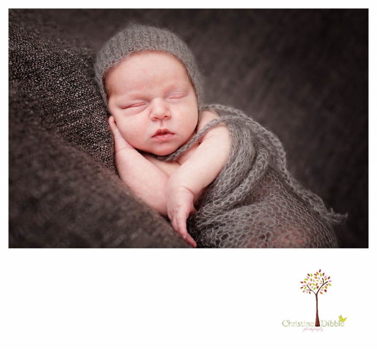 Christine Dibble Photography takes Sonora newborn photography portraits takes photos of a baby boy wearing gray mohair as he sleeps.