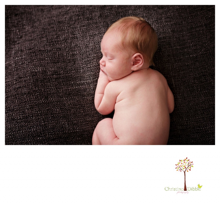 Christine Dibble Photography takes Sonora newborn photography portraits takes photos of newborn back rolls.