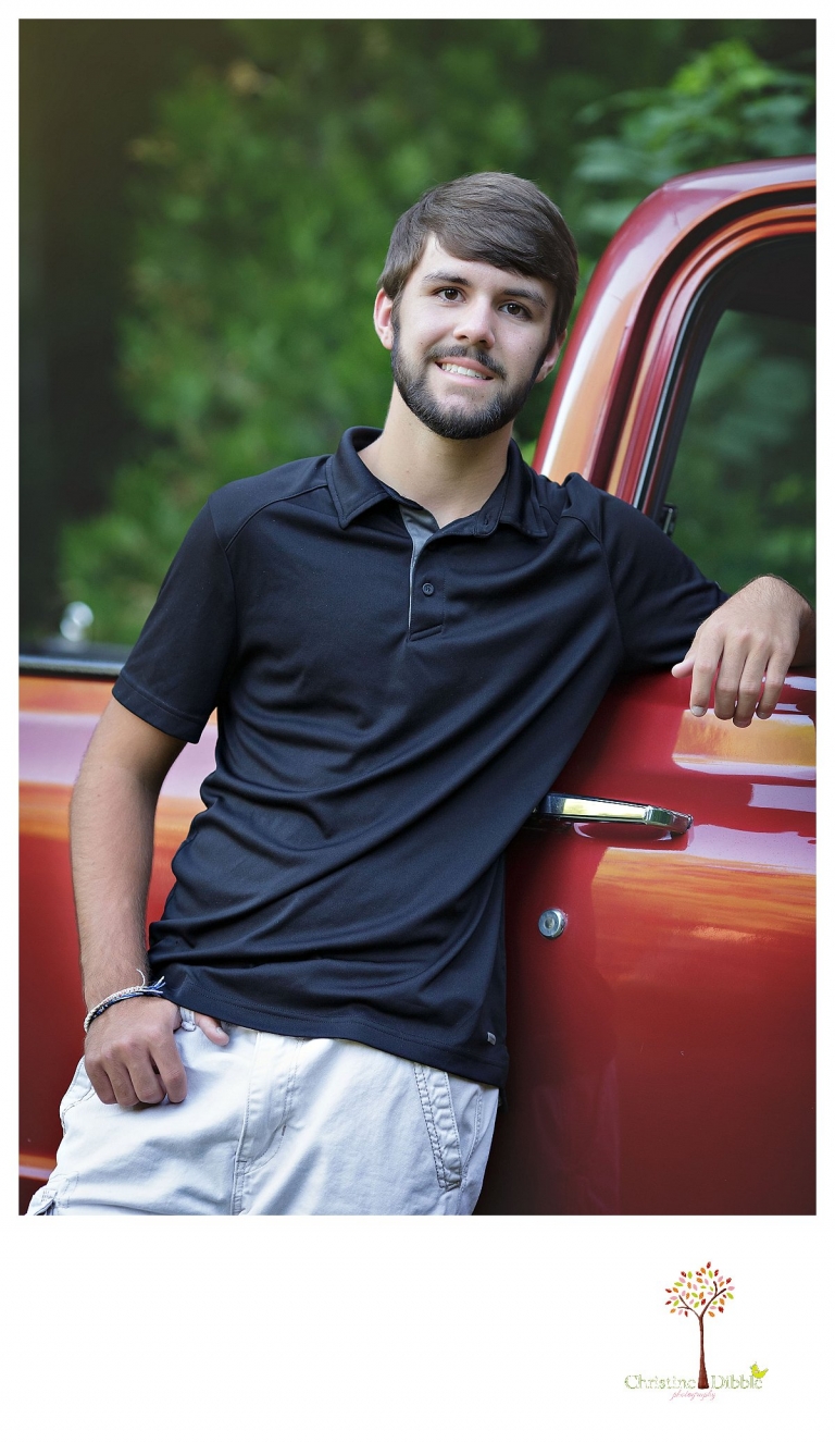 Sonora and Summerville senior portrait photographer Christine Dibble Photography takes senior portraits of a boy at Twain Harte Tree Farm with the red Chevy truck his grandfather gave him.