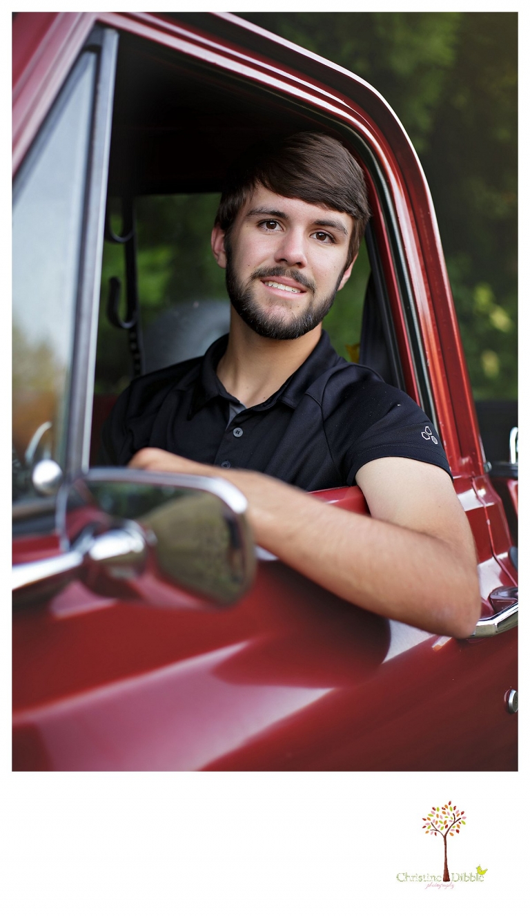 Sonora and Summerville senior portrait photographer Christine Dibble Photography takes senior portraits of a boy in the driver's seat of his red Chevy truck at Twain Harte Tree Farm.