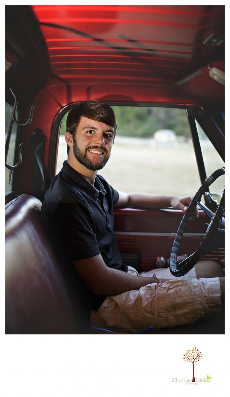 Sonora and Summerville senior portrait photographer Christine Dibble Photography takes senior portraits of a boy at Twain Harte Tree Farm as he sits in the driver's seat of his truck.