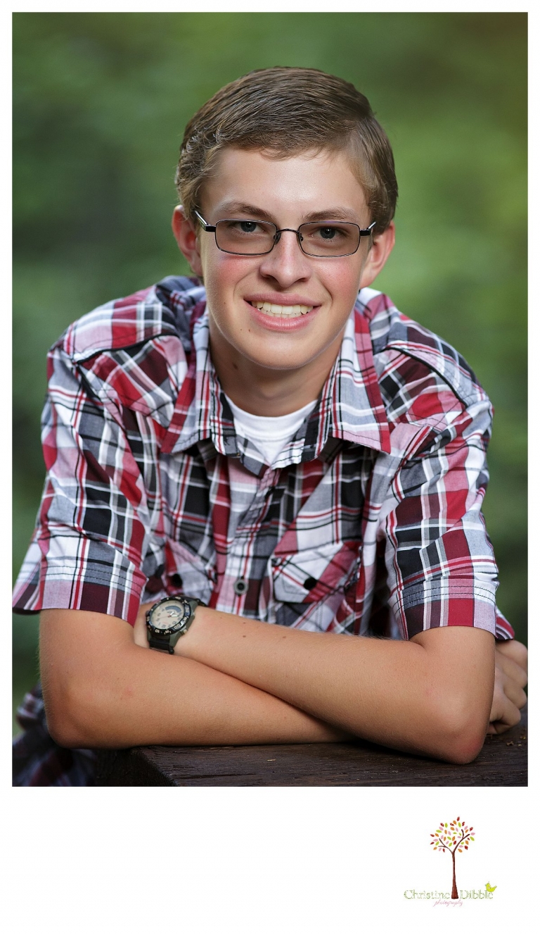 Christine Dibble Photography, Summerville and Sonora senior portrait photographer, takes photos including head shots of a boy in a wooded setting.