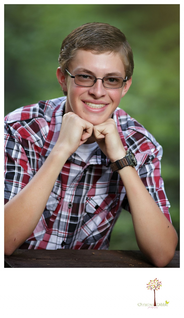 Christine Dibble Photography, Summerville and Sonora senior portrait photographer, takes photos of a boy in a plaid shirt.